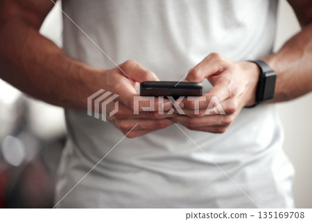 Fitness, app and man with phone, checking workout schedule or social media at gym for sports training. Athlete with digital application, heart rate tracker and exercise tech, health and cellphone. 135169708