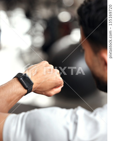Fitness, app and man with smart watch, time and workout schedule online at gym and sports training. Athlete with digital application, heart rate tracker and tech for exercise and health on stopwatch. 135169720