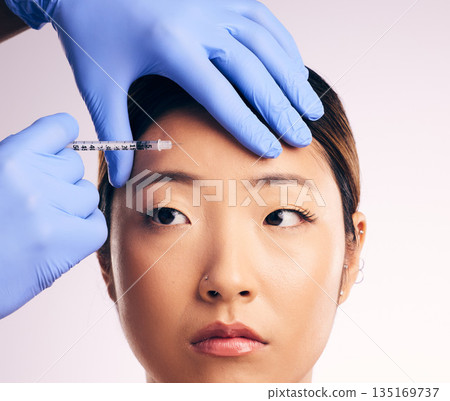 Forehead injection, face skincare and Asian woman in studio isolated on a white background. Cosmetics, syringe and female model with collagen filler, dermatology and prp facelift in plastic surgery. 135169737