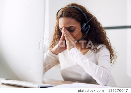 Call center, headache and woman with stress for computer problem, burnout and brain fog for consulting. Tired female telemarketing consultant at desktop with crisis, anxiety and bad customer service 135170047