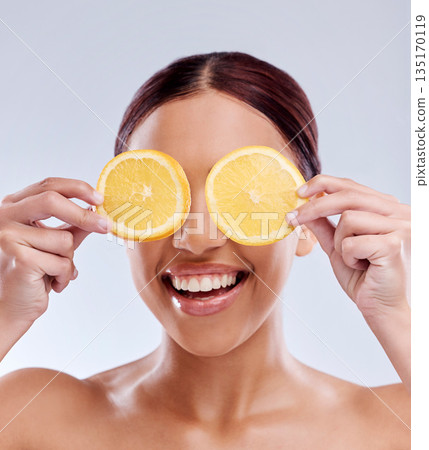 Skincare, mockup or happy girl with orange as natural facial with citrus or vitamin c for wellness. Studio background, smile or healthy female model smiling with organic fruits for dermatology beauty Skincare, mockup or happy girl with orange as natural facial with citrus or vitamin c for wellness. Studio background, smile or healthy female model smiling with organic fruits for dermatology beauty 135170119