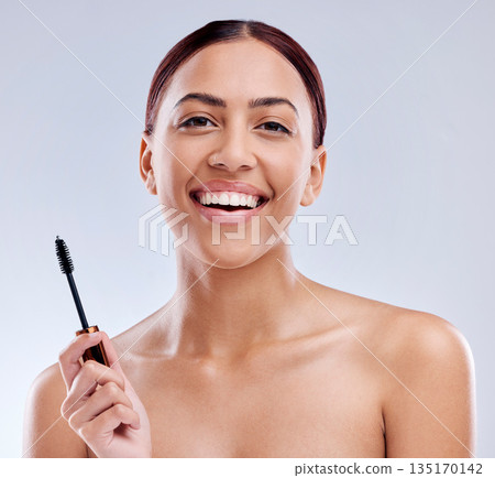 Portrait, beauty or happy girl with mascara makeup, cosmetics or product brush laughing in studio. Smile, face or female model smiling with eyelashes tool for make up or self care on white background 135170142