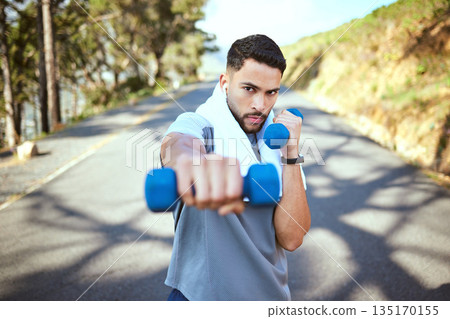 Man, dumbbell and punch in nature fitness for exercise, workout or training in the outdoors. Portrait of fit, active and sporty male person punching with weights in healthy outdoor cardio endurance 135170155