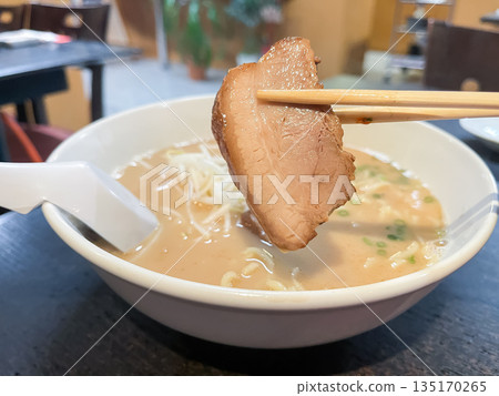Creamy tonkotsu ramen, a famous noodle dish from the Kyushu region of Japan, topped with bean sprouts, wood ear mushrooms, and roasted pork. Creamy tonkotsu ramen, a famous noodle dish from the Kyushu region of Japan, topped with bean sprouts, wood ear mushrooms, and roasted pork. 135170265