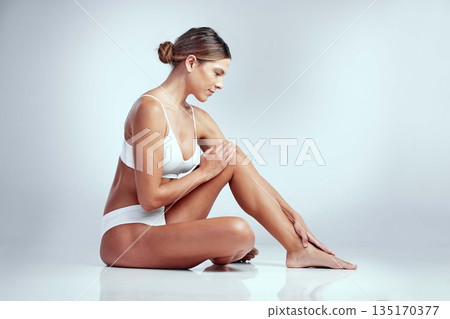 Underwear, beauty and legs of woman on floor in studio isolated on white background mockup space. Lingerie, body and female model sitting with pedicure, grooming or hair removal, epilation or waxing 135170377