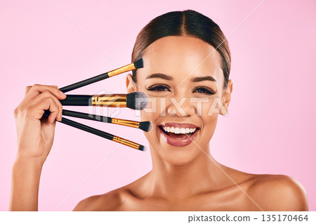 Happy woman, portrait smile and makeup brushes for beauty cosmetics against a pink studio background. Isolated female person or model smiling in satisfaction for cosmetic tools, grooming or facial Happy woman, portrait smile and makeup brushes for beauty cosmetics against a pink studio background. Isolated female person or model smiling in satisfaction for cosmetic tools, grooming or facial 135170464