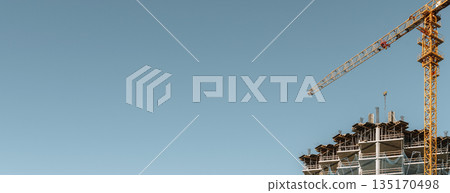 Construction of a building banner background. Construction site with crane. Business, development, industry. Construction of a building banner background. Construction site with crane. Business, development, industry. 135170498