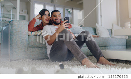 Phone, happy and couple on sofa in home for social media, online website and internet news. Communication, relationship and man and woman relax on smartphone for quality time, bonding and network 135170513