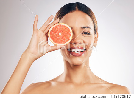 Grapefruit, skincare and woman smile in studio for natural cosmetic, eco or beauty on grey background. Citrus, facial and female model relax with fruit for vegan, detox and vitamin c for glowing skin Grapefruit, skincare and woman smile in studio for natural cosmetic, eco or beauty on grey background. Citrus, facial and female model relax with fruit for vegan, detox and vitamin c for glowing skin 135170617