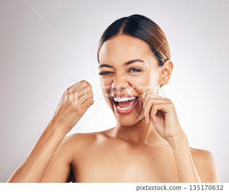 Dental, portrait and happy woman flossing teeth in studio for hygiene, wellness and fresh breath on grey background. Face, floss and female relax with mouth, tooth and cleaning for oral care routine Dental, portrait and happy woman flossing teeth in studio for hygiene, wellness and fresh breath on grey background. Face, floss and female relax with mouth, tooth and cleaning for oral care routine 135170632