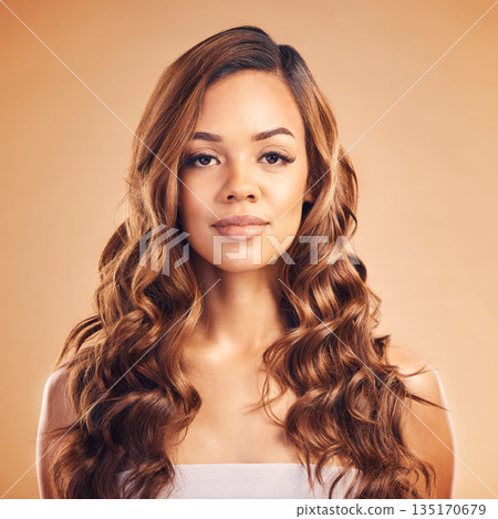 Woman in portrait, hair and beauty with hairstyle and shine, haircare and keratin treatment on studio background. Female model with color highlights, balayage and cosmetic care with texture and curls 135170679