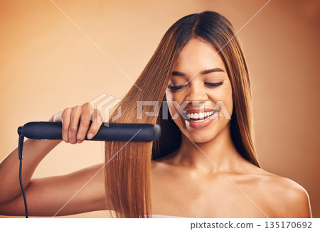 Woman, hair and beauty, flat iron and smile, haircare and keratin treatment isolated on studio background. Female model with highlights, electric straightener and heat, happy with growth and texture Woman, hair and beauty, flat iron and smile, haircare and keratin treatment isolated on studio background. Female model with highlights, electric straightener and heat, happy with growth and texture 135170692