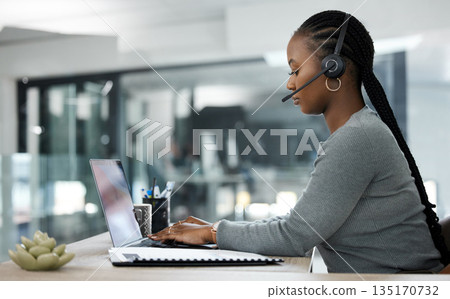 Black woman, laptop and call center in customer service, telemarketing or support at the office desk. African female person, consultant or agent typing on computer with headphones for online advice Black woman, laptop and call center in customer service, telemarketing or support at the office desk. African female person, consultant or agent typing on computer with headphones for online advice 135170732