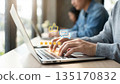 User typing on laptop with 5 star rating and review icons. 135170832