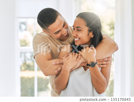 Couple, hug and smile in home for love, care and relax for romance, support and trust of bond together. Happy man, woman and hugging partner for quality time, happiness and commitment to relationship Couple, hug and smile in home for love, care and relax for romance, support and trust of bond together. Happy man, woman and hugging partner for quality time, happiness and commitment to relationship 135170845