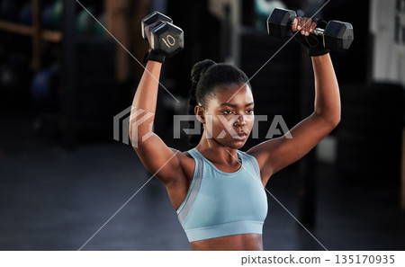 Fitness, dumbbells or strong girl training, exercise or workout for powerful arms or muscles development. Wellness, health or black woman lifting weights or exercising shoulders in gym club studio Fitness, dumbbells or strong girl training, exercise or workout for powerful arms or muscles development. Wellness, health or black woman lifting weights or exercising shoulders in gym club studio 135170935