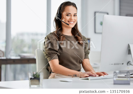 Online communication, portrait of a woman with headset and computer at her desk in a modern office workplace. Telemarketing or call center, crm and female person at her workspace for customer service Online communication, portrait of a woman with headset and computer at her desk in a modern office workplace. Telemarketing or call center, crm and female person at her workspace for customer service 135170936