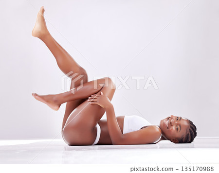 Skincare, legs and portrait of black woman on studio floor for shaving, hair grooming and wellness. Beauty, underwear and female person on white background for cosmetics, natural skin or body care Skincare, legs and portrait of black woman on studio floor for shaving, hair grooming and wellness. Beauty, underwear and female person on white background for cosmetics, natural skin or body care 135170988