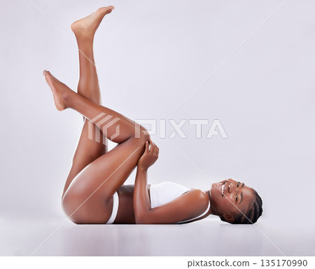 Beauty, legs and portrait of black woman on studio floor for shaving, hair grooming and wellness. Skincare, underwear and female person on white background for cosmetics, natural skin or body care 135170990