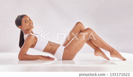 Woman lying down in underwear, body and beauty in portrait, smile with hair removal and skincare on studio background. Happy female model, natural cosmetics and epilation, dermatology and grooming Woman lying down in underwear, body and beauty in portrait, smile with hair removal and skincare on studio background. Happy female model, natural cosmetics and epilation, dermatology and grooming 135171022