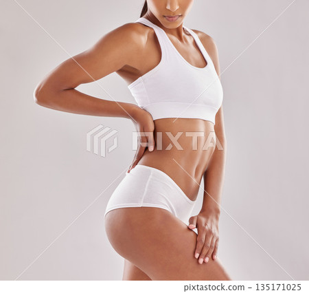 Body, wellness and woman in underwear in studio for diet, positivity and self love on grey background. Detox, beauty and female model with slim, stomach or bodycare in lingerie posing with confidence Body, wellness and woman in underwear in studio for diet, positivity and self love on grey background. Detox, beauty and female model with slim, stomach or bodycare in lingerie posing with confidence 135171025