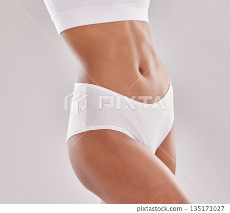 Body, care and woman in underwear in studio for diet, wellness and self love on grey background. Detox, beauty and female model with slim, stomach or bodycare in lingerie posing with confidence 135171027