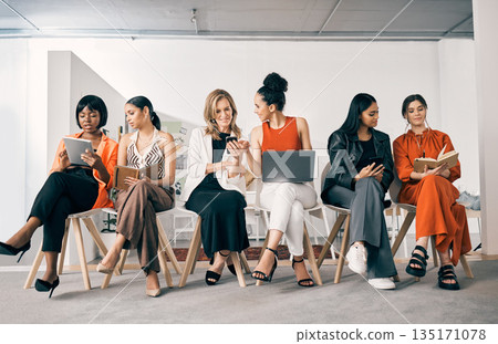 Waiting room, networking and business women with job search on phone, tablet and laptop or notebook planning. Gender equality, diversity and group of people talking, teamwork and career collaboration 135171078