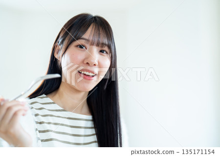 A young woman who makes a meal A young woman who makes a meal 135171154