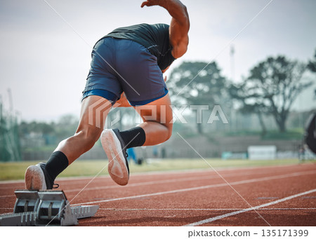 Stadium, man running and start block of athlete on a runner and arena track for sprint race training. Back, run and sports exercise of male person in marathon for fitness and workout outdoor on field Stadium, man running and start block of athlete on a runner and arena track for sprint race training. Back, run and sports exercise of male person in marathon for fitness and workout outdoor on field 135171399