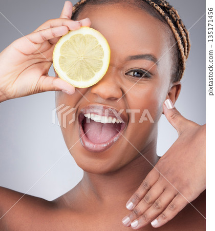 Beauty, lemon and portrait with black woman in studio for natural, cosmetics and vitamin c. Nutrition, diet and detox with face of female model on grey background for citrus fruit and health product Beauty, lemon and portrait with black woman in studio for natural, cosmetics and vitamin c. Nutrition, diet and detox with face of female model on grey background for citrus fruit and health product 135171456