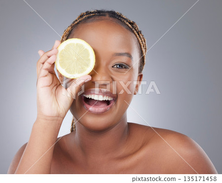 Beauty, lemon and smile with portrait of with black woman in studio for natural, cosmetics and vitamin c. Nutrition, diet and detox with model on grey background for citrus fruit and health product Beauty, lemon and smile with portrait of with black woman in studio for natural, cosmetics and vitamin c. Nutrition, diet and detox with model on grey background for citrus fruit and health product 135171458