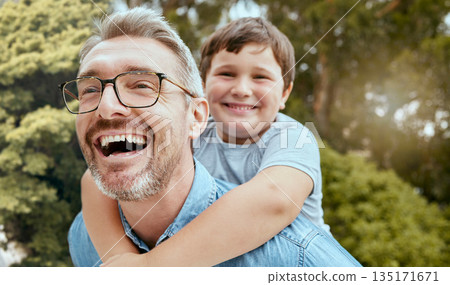 Family fun, piggyback and father with child in a park happy, playing and laughing in nature. Hug, love and parent carrying son in a garden, laugh and enjoying games, smile and together on the weekend 135171671