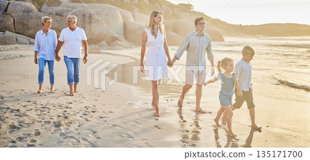 Family generations, walking and beach with sunset for men, women and children with love on holiday. Parents, grandparents and kids by ocean, holding hands and bond on summer vacation with solidarity Family generations, walking and beach with sunset for men, women and children with love on holiday. Parents, grandparents and kids by ocean, holding hands and bond on summer vacation with solidarity 135171700