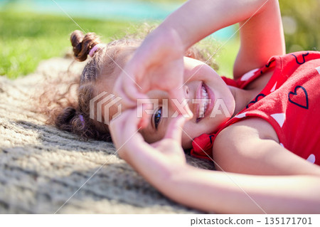 Portrait, smile and girl with a heart shape, outdoor and sunshine with happiness, carefree and relax. Face, female child and kid with symbol for love, freedom and cheerful with a young person and joy Portrait, smile and girl with a heart shape, outdoor and sunshine with happiness, carefree and relax. Face, female child and kid with symbol for love, freedom and cheerful with a young person and joy 135171701