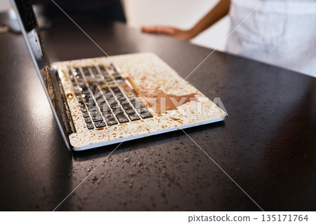 Remote work, accident and coffee splash on laptop in a kitchen, crisis and problem for woman working from home. Freelance, chaos and tea spill on a keyboard by female freelancer with computer damage Remote work, accident and coffee splash on laptop in a kitchen, crisis and problem for woman working from home. Freelance, chaos and tea spill on a keyboard by female freelancer with computer damage 135171764