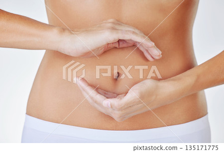 Hands frame, stomach and woman in studio showing gut health, wellness and weight loss. Digestion, female person and hand by abdomen with circle for healthy body care and fitness with white background 135171775