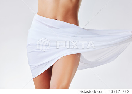 Closeup, fabric and woman with skincare, stomach and lady isolated against a white studio background. Zoom, female person and model with material, cover and dermatology with cosmetics and belly 135171780