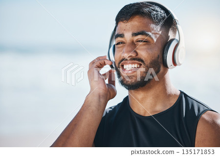 Happy, beach and a man with music for fitness, running motivation and ideas in nature. Smile, wellness and an athlete listening or streaming a podcast while training or exercise vision at the sea Happy, beach and a man with music for fitness, running motivation and ideas in nature. Smile, wellness and an athlete listening or streaming a podcast while training or exercise vision at the sea 135171853