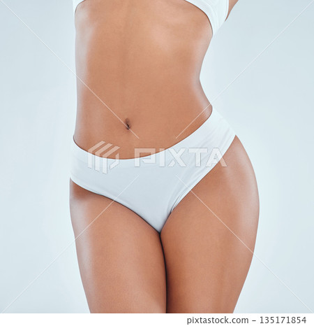 Body, stomach and a woman with underwear for femininity isolated on a white background in studio. Skin, healthy and a toned person and legs of a girl in lingerie for wellness and feminine empowerment Body, stomach and a woman with underwear for femininity isolated on a white background in studio. Skin, healthy and a toned person and legs of a girl in lingerie for wellness and feminine empowerment 135171854