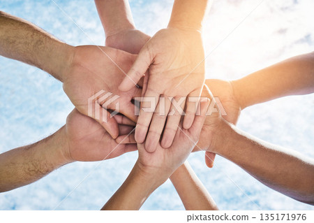 Hands in circle together, blue sky and community in collaboration for world support, trust and diversity. Teamwork, hand and summer sunshine, positive mindset and group of people in solidarity huddle 135171976