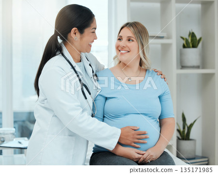 Healthcare, comfort and doctor with a pregnant woman in a clinic touching her belly for support. Maternity, wellness and female nurse hugging a patient with pregnancy during a prenatal consultation. 135171985
