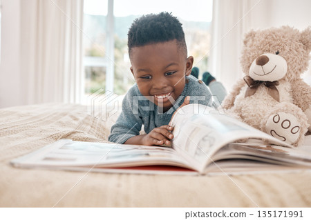 Young african boy, reading and bed for story, book and learning with smile in family home, focus and excited. Black male child, education and relax in bedroom with happiness, study or comic in house Young african boy, reading and bed for story, book and learning with smile in family home, focus and excited. Black male child, education and relax in bedroom with happiness, study or comic in house 135171991