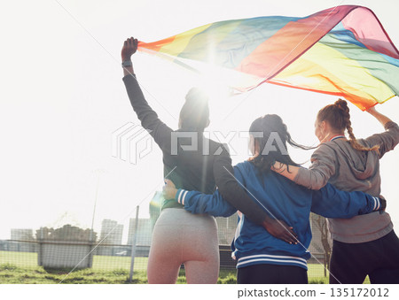 Fitness, rainbow flag and female athletes outdoor for pride, health and wellness achievement. Sports, love and women friends embracing while walking for political homosexual equality and lgbtq rights Fitness, rainbow flag and female athletes outdoor for pride, health and wellness achievement. Sports, love and women friends embracing while walking for political homosexual equality and lgbtq rights 135172012