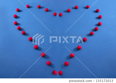 Heart, pattern and tennis ball on a floor for fitness, health lifestyle and cardiovascular exercise in empty studio. Red, balls and sports equipment in frame for cardio wellness, message and workout 135172013