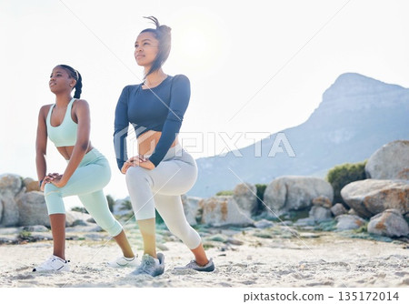 Stretching, fitness and friends with women at beach for running, yoga and workout. Relax, health and wellness with female runner and warm up in nature for training, teamwork and cardio performance 135172014