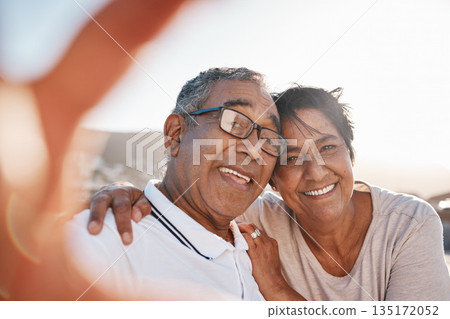 Selfie, romance and a senior couple on the beach together during summer for a retirement holiday or vacation. Portrait, smile or dating with an old husband and wife posing for a photograph by the sea Selfie, romance and a senior couple on the beach together during summer for a retirement holiday or vacation. Portrait, smile or dating with an old husband and wife posing for a photograph by the sea 135172052