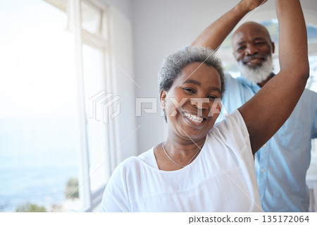 Black senior couple, dancing and together in a happy home with love, care and commitment. Portrait of a african woman and man to celebrate marriage, retirement lifestyle and happiness with a dance 135172064