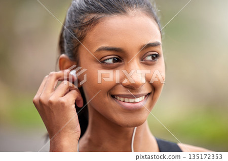 Smile, thinking and a woman with music while training, running or doing cardio in nature. Happy, ideas and face of an athlete with idea for a podcast, audio or radio during an outdoor workout Smile, thinking and a woman with music while training, running or doing cardio in nature. Happy, ideas and face of an athlete with idea for a podcast, audio or radio during an outdoor workout 135172353