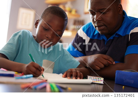 Homeschool, father and kid with color pencils for education, learning and creative development in family home. Dad, child and books for writing, drawing and creativity of art project, homework or fun 135172401