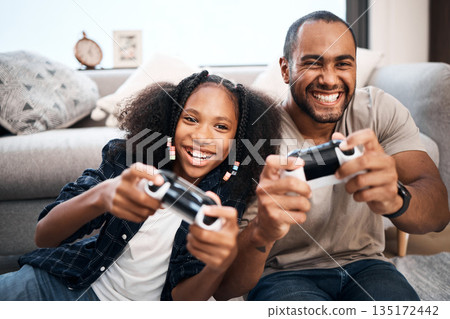 Gaming, family or children with a father and daughter in the living room of their home playing a video game together. Kids, happy or fun with a gamer dad and girl child in the house to play online Gaming, family or children with a father and daughter in the living room of their home playing a video game together. Kids, happy or fun with a gamer dad and girl child in the house to play online 135172442